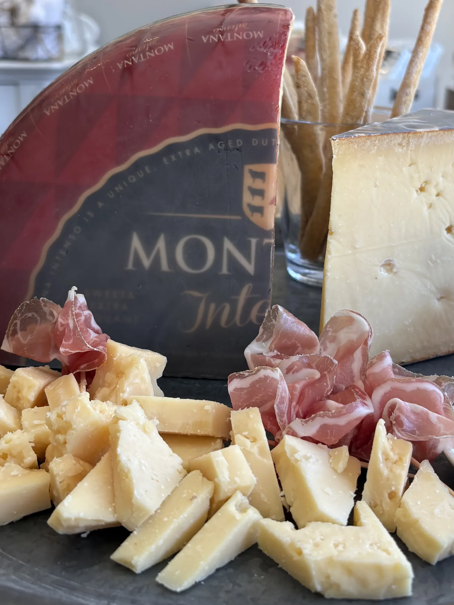 Wedges of Montasio and other cheeses with prosciutto